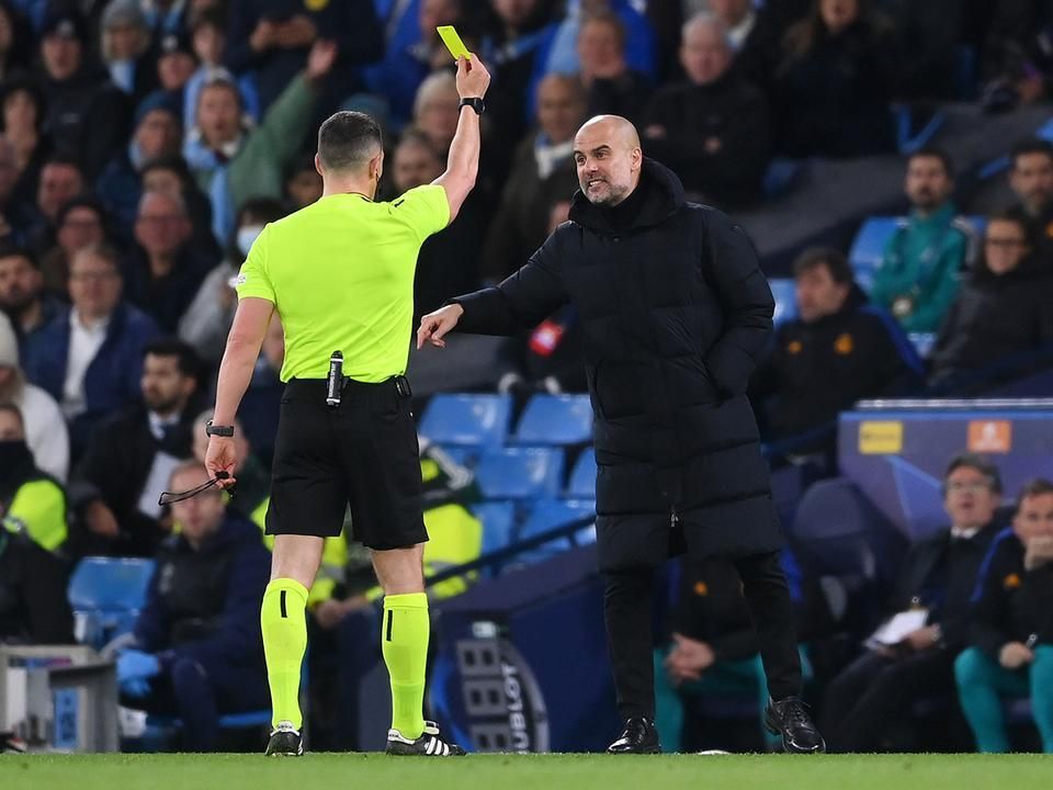 István Kovács gives a yellow card to the complaining Pep Guardiola (Photo: Getty Images)