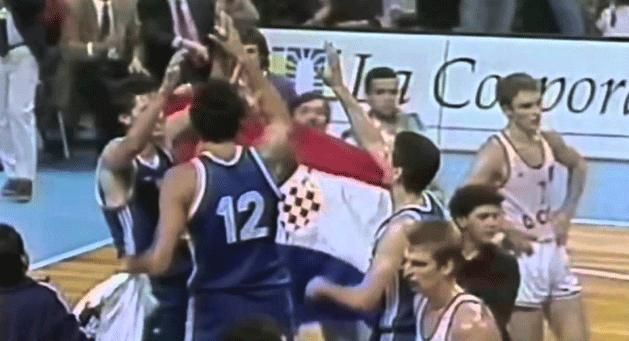 While celebrating the World Championship victory, a fan ran onto the court with the Croatian flag, and Vlade Divac (12) took it away from him