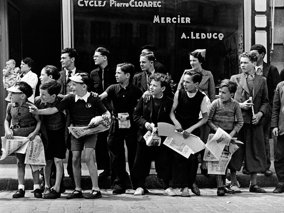 A híres 1939-es Tour de France-fotó, a képen látszik, mennyire várják az elsuhanó mezőnyt a gyerekek, jelképes, hogy Monsieur Cloarec kerékpárosüzlete előtt izgulnak