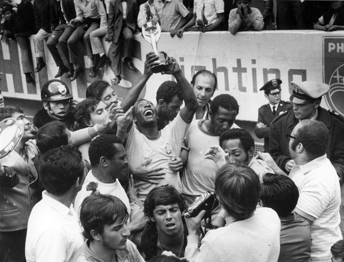 1970 FIFA World Cup in Mexico Pele (Edson Arantes do Nascimento) 1940 - Brazilian football player, 1994 Minister of Sports in Brazil - Celebrating Pele, surrounded by teammates, is raising the Jues Rimet Trophy after beating Italy in the final - June