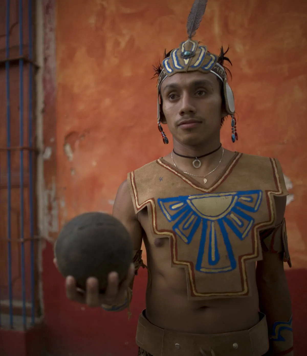 A Mayan ball player holds up the ball made of hule natural rubber in Chapab village in Yucatan sta