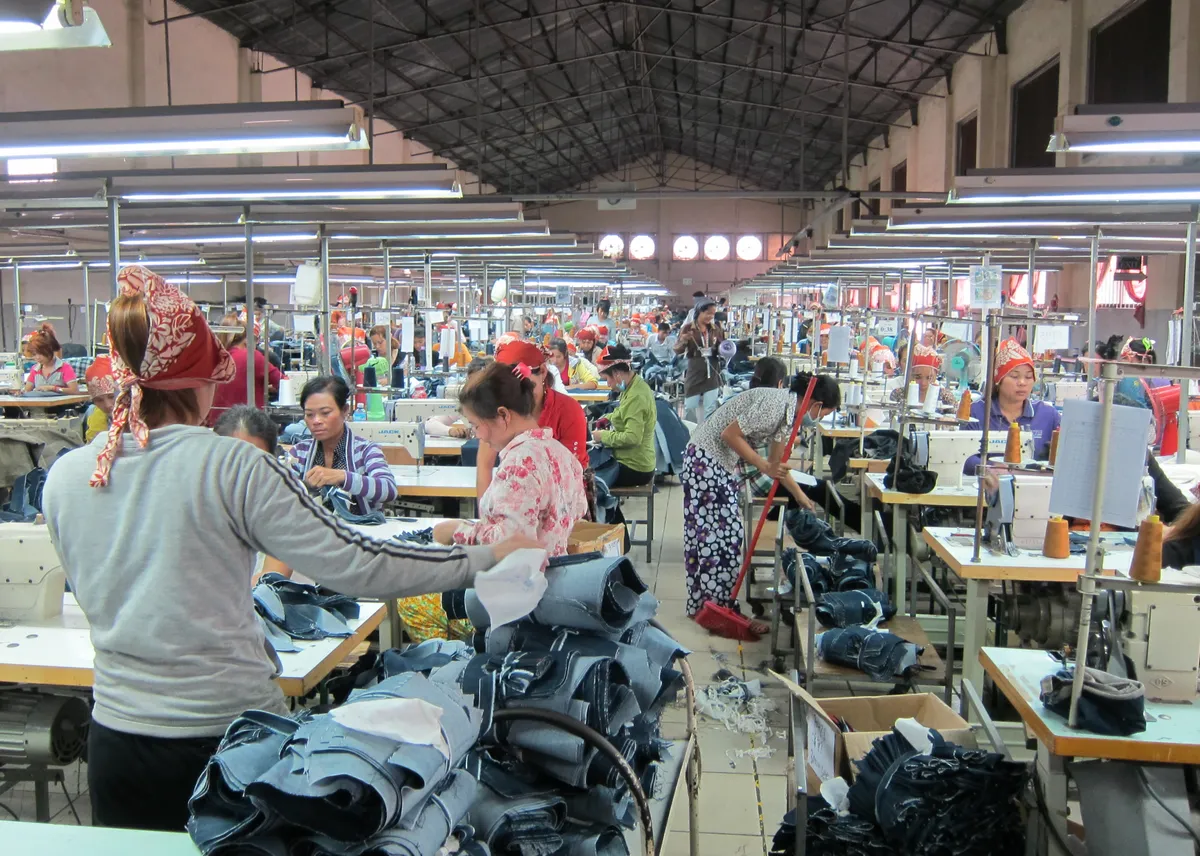 Cambodian workers manufacture jeans at a factory owned partly by Cambodian Chinese, David Tan Kok-ngan, in Phnom Penh, Cambodia, on December 7, 2011. 07DEC11